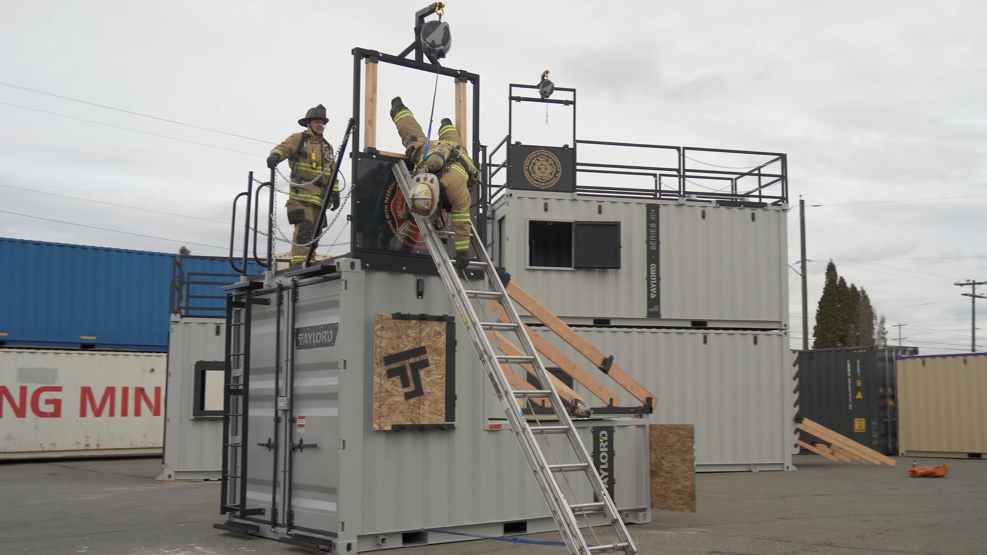 Firefighters running a bailout window rescue drill on a Taylor'd training tower